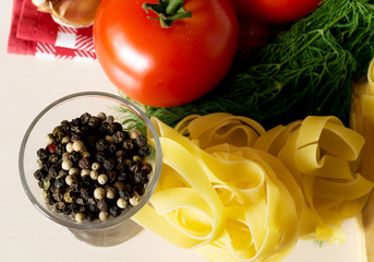 Ingredients for cooking pasta with tomatoes and herbs