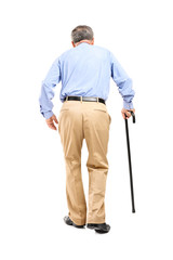 Full length portrait of a senior man with cane walking