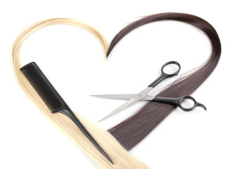 Shiny blond and brown hair with hair cutting shears