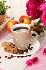cup of coffee, cookies, apples and flowers on table in cafe