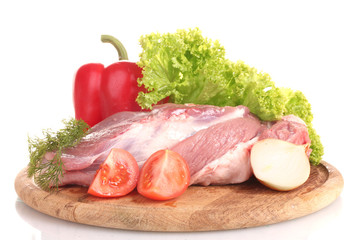 Raw meat and vegetables on a wooden board isolated on whitе
