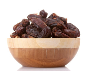 delicious dried dates in wooden bowl isolated on white