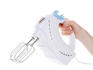 electric mixer in hand isolated on white.