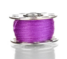 Metal spool of thread isolated on white