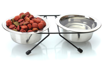 dry dog food and water in metal bowls isolated on white