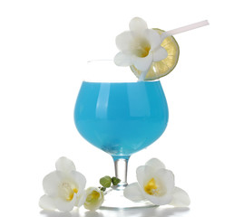 glass of blue cocktail with lime and flowers isolated on white