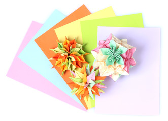 Colorfull origami kusudamas and bright paper isolated on white