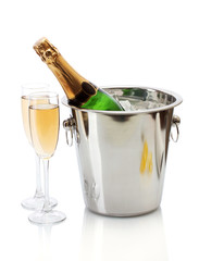 Champagne bottle in bucket with ice and glasses of champagne,