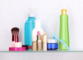 Shelf with cosmetics and toiletries in bathroom