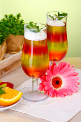 fruit jelly in glasses and fruits on table in cafe