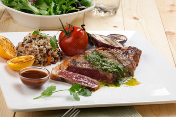 Piece of Medium Rare Steak with Spicy Herb Sauce