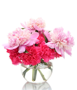 Bouquet of carnations and peonies in glass vase isolated