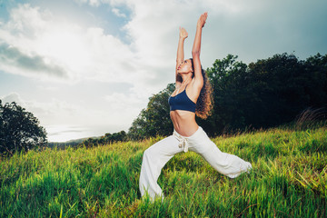 Fototapeta na wymiar Beautiful Woman Practicing Yoga Outside in Nature