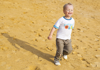 Boy running on the sand