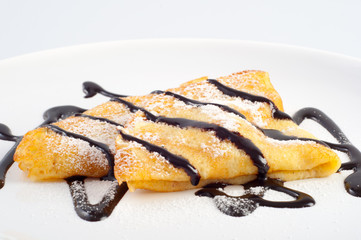 Pancakes with chocolate and powdered sugar
