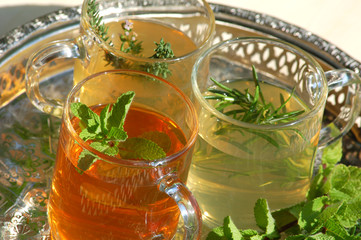Cups with herbal tea with rosemary, mint ,thyme