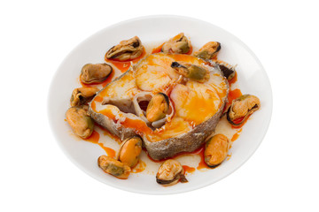 boiled fish with sauce and mussels on the white plate