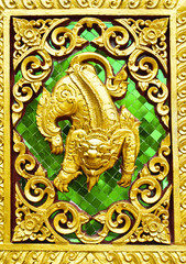 Fototapeta na wymiar Animal carvings on the doors of the temple in the novel in a Tha