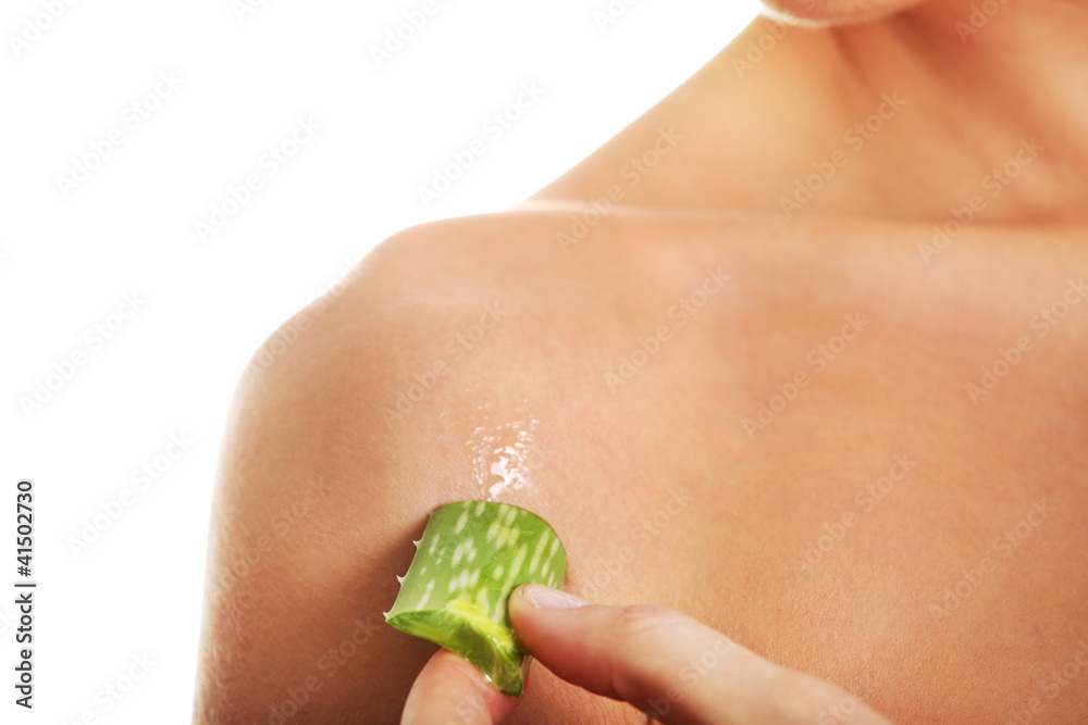 Wall mural young woman using aloe vera