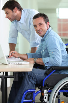 Man in wheelchair at desk