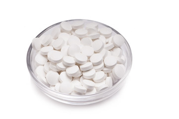 Pills in bowl isolated on white