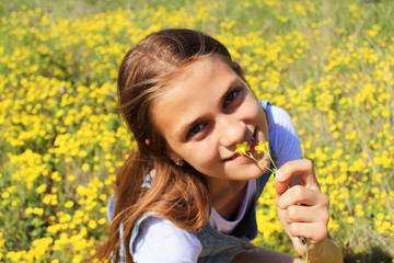 Girl on the nature of a flowered