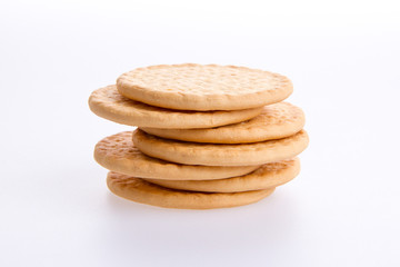 A stack of round biscuits on a grey background