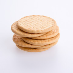 A stack of round biscuits on a grey background