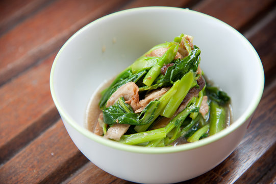 Stir-fried mix colorful vegetables and herb in white round bowl