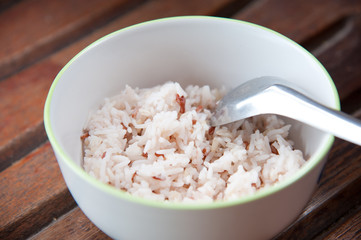 White and brown steamed rice in white round bowl