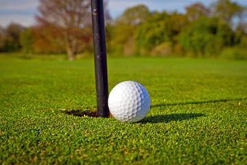 Golf ball near the hole