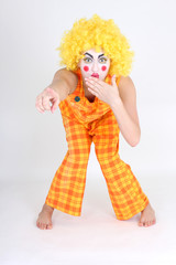 Clown in colourful costume showing something