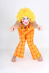 Clown in colourful costume showing hands