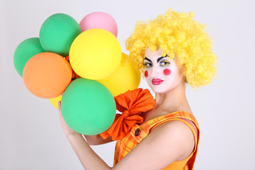 Funny clown with colourful balloons