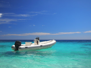 Speedboat in an emerald sea