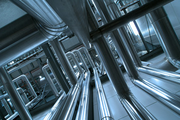 Equipment, cables and piping as found inside of a modern industr