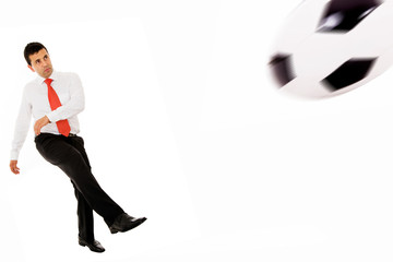 Businessman playing soccer isolated in white