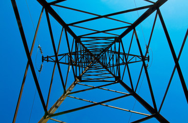 Pylon & power lines against blue sky