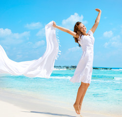 Fototapeta na wymiar Piękna Dziewczyna Z Białym Skoki Szalik na plaży