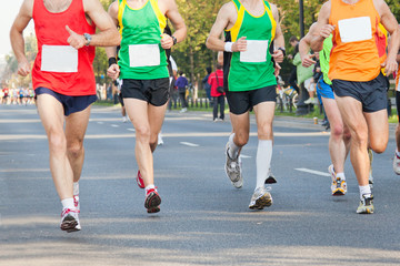 Runners running in city marathon on street