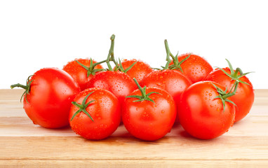 Fresh wet tomatoes on a cutting board wooden Isolated on white b