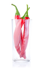 Three Red Hot Pepper in the glass isolated on a white background