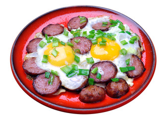 Fried eggs with sausage in a red plate