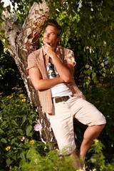 Young man meditating in the green