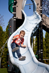 Little boy on the playground slide - 41533775