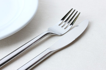 fork, knife and plate isolated on white