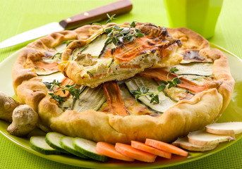 vegetables cake over dish on green background