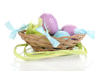 Colorful easter eggs in basket isolated on white