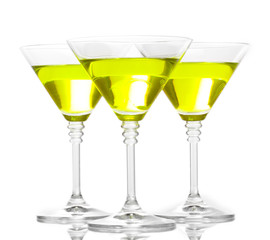 Yellow cocktail in martini glasses isolated on white