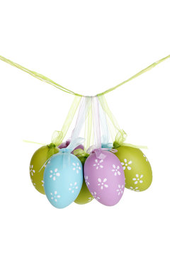 Colorful easter eggs hanging on ribbons isolated on white
